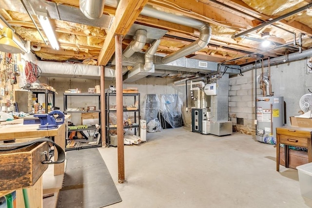 unfinished basement featuring gas water heater, heating unit, and visible vents