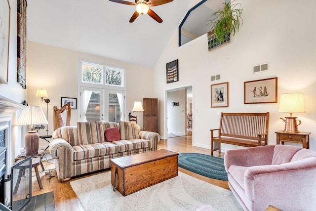 living room with visible vents, french doors, light wood-type flooring, and ceiling fan