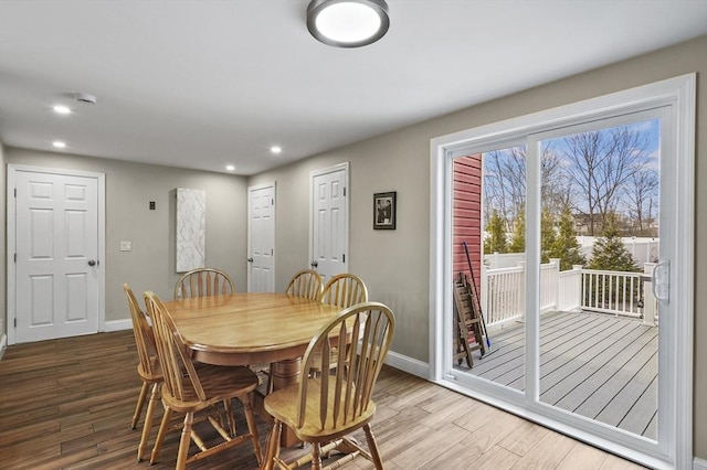 dining space with recessed lighting, wood finished floors, and baseboards