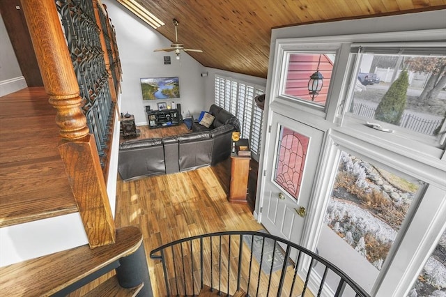 stairs with vaulted ceiling, wooden ceiling, ceiling fan, and wood finished floors