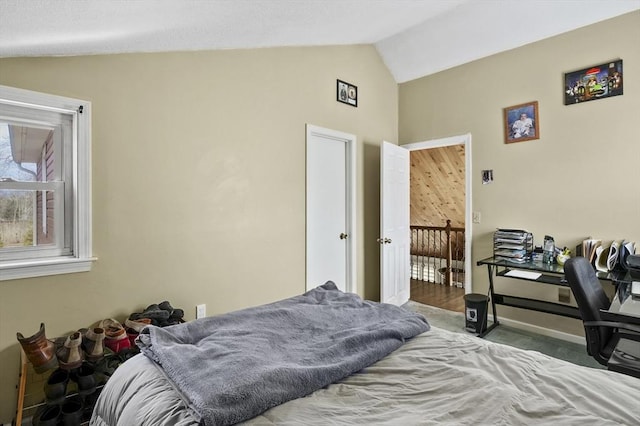 bedroom featuring baseboards and vaulted ceiling