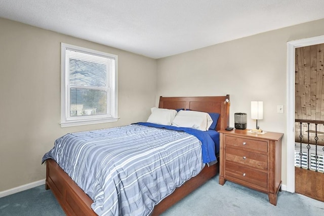 bedroom with baseboards and carpet floors