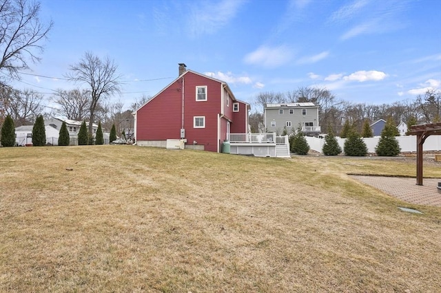 exterior space featuring a lawn, a chimney, and fence