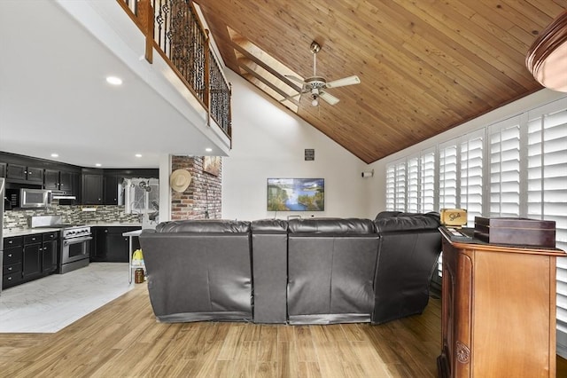 living room featuring stairway, a ceiling fan, light wood finished floors, high vaulted ceiling, and wooden ceiling