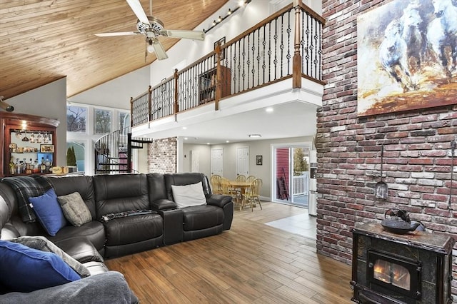 living room with wood finished floors, stairs, wood ceiling, a towering ceiling, and a wealth of natural light