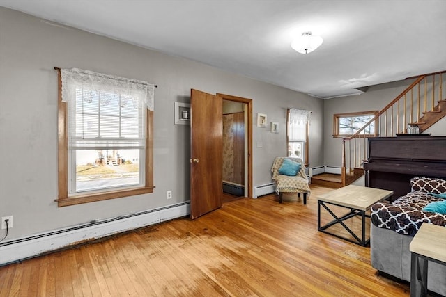 interior space featuring baseboard heating and light hardwood / wood-style flooring