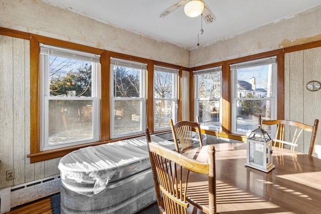 sunroom with a baseboard radiator and ceiling fan