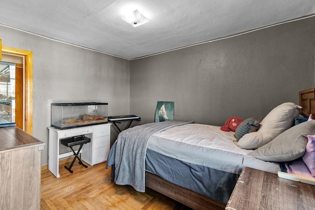 bedroom featuring light parquet flooring