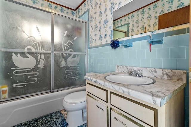 full bathroom featuring tile walls, vanity, bath / shower combo with glass door, and toilet