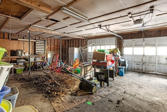 garage with a garage door opener and fridge