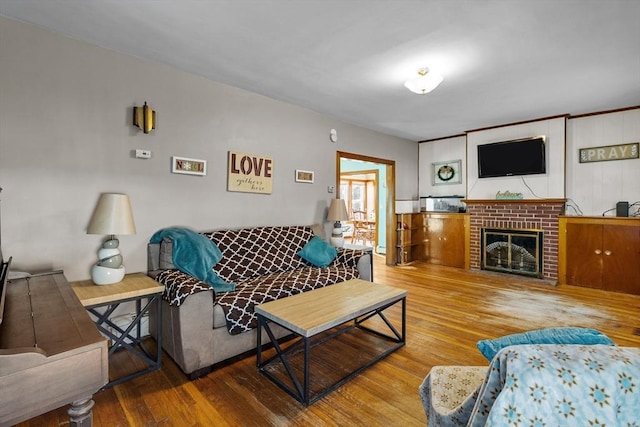 living room featuring wood-type flooring and a fireplace