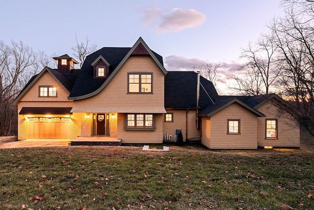 back house at dusk featuring a yard