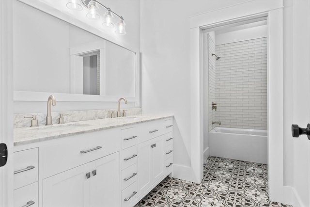 bathroom featuring tile patterned flooring, vanity, and tiled shower / bath