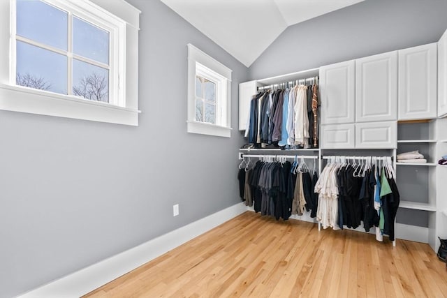 spacious closet featuring light wood-type flooring and lofted ceiling