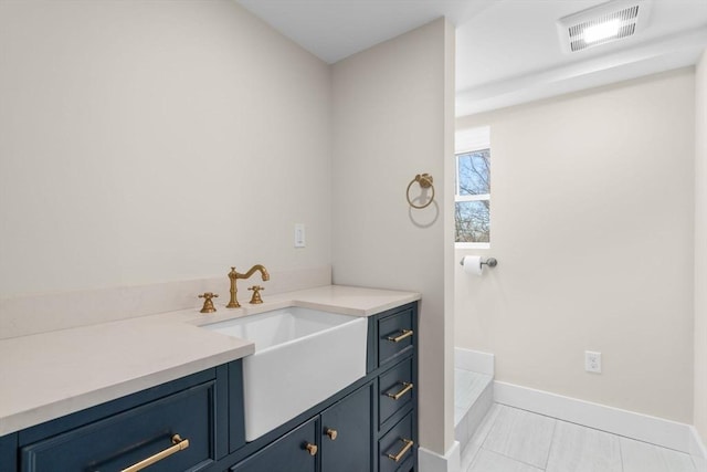 bathroom with sink and tile patterned flooring