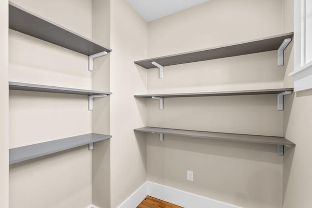 spacious closet featuring hardwood / wood-style flooring