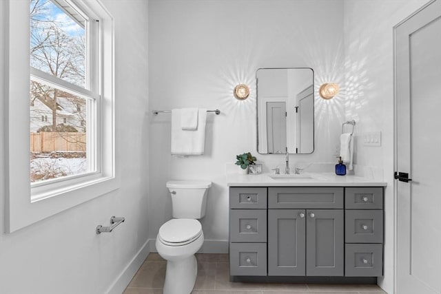 bathroom with vanity, tile patterned floors, and toilet