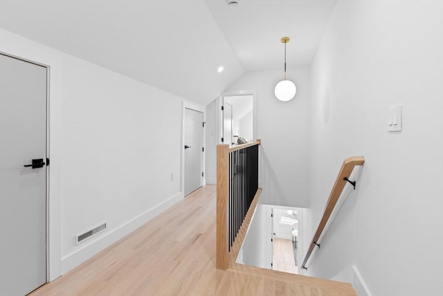 corridor featuring vaulted ceiling and light hardwood / wood-style floors