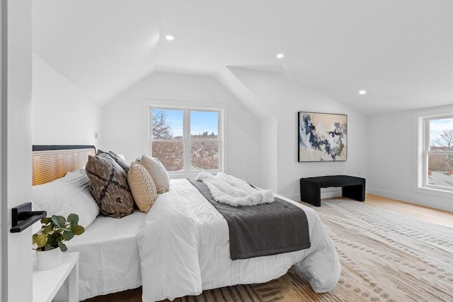 bedroom featuring lofted ceiling and light hardwood / wood-style flooring