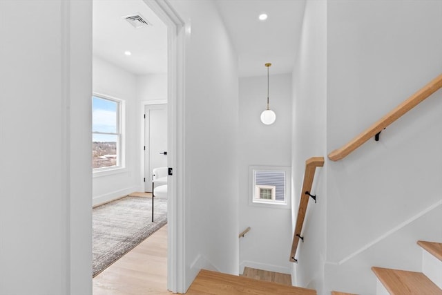 staircase featuring wood-type flooring