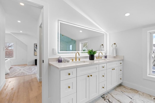 bathroom featuring vanity and vaulted ceiling