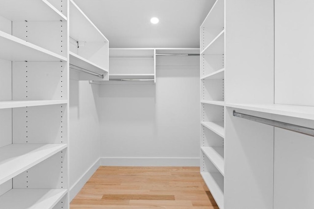 spacious closet with light hardwood / wood-style flooring