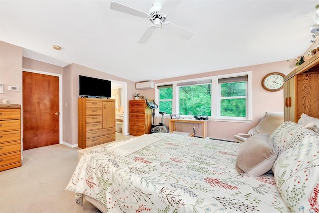 bedroom featuring a wall unit AC, carpet flooring, lofted ceiling, ceiling fan, and ensuite bathroom