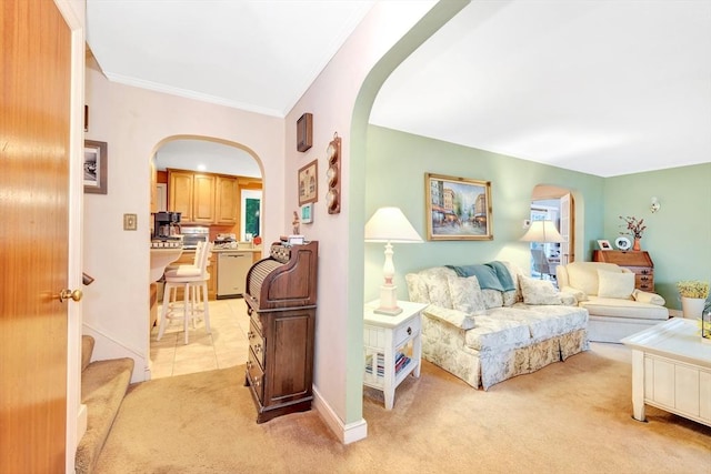 living room with arched walkways, light carpet, ornamental molding, and baseboards