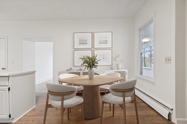 dining area with baseboard heating and wood-type flooring