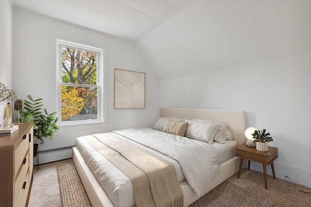 carpeted bedroom featuring a baseboard radiator and vaulted ceiling