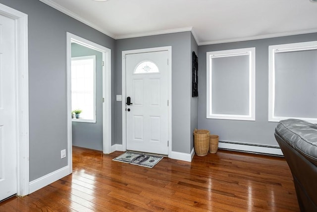 foyer featuring ornamental molding, dark hardwood / wood-style flooring, and a baseboard heating unit