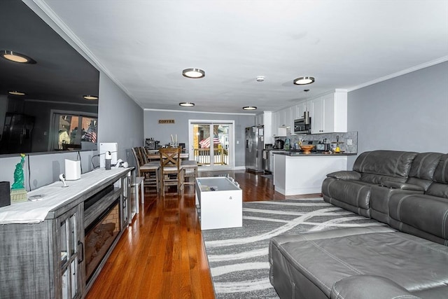 living room with dark wood-type flooring and ornamental molding