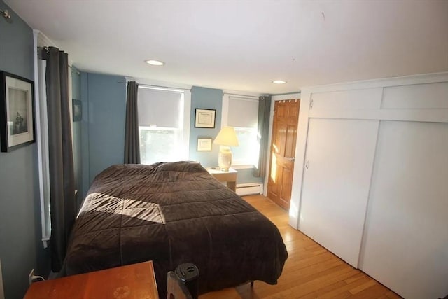 786 Cabot St, Beverly, MA 01915 - bedroom featuring light wood-type flooring, a baseboard radiator, recessed lighting, and a closet