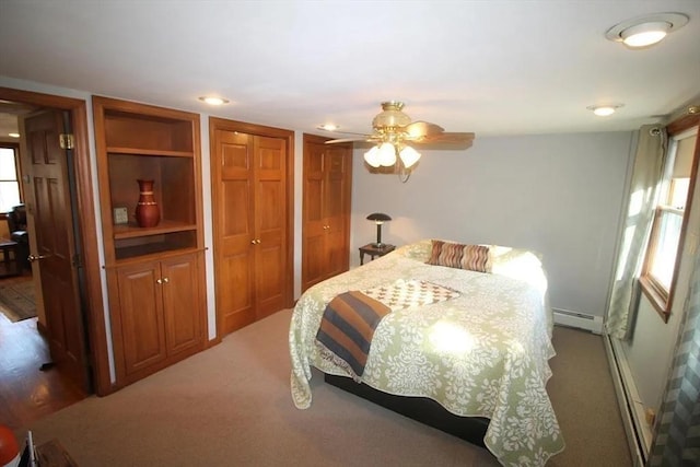 786 Cabot St, Beverly, MA 01915 - bedroom with carpet floors, a baseboard heating unit, two closets, and ceiling fan