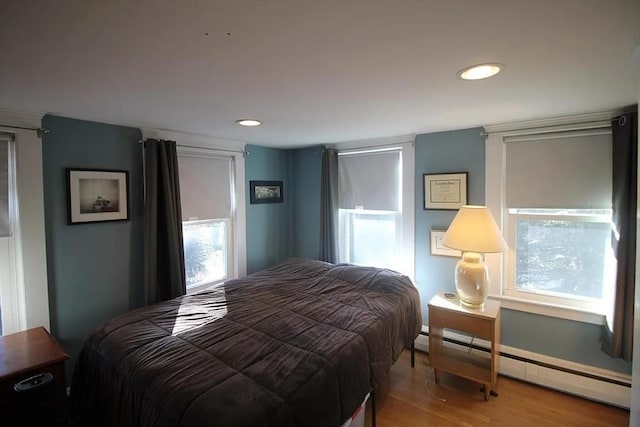 786 Cabot St, Beverly, MA 01915 - bedroom with a baseboard heating unit, wood finished floors, and recessed lighting
