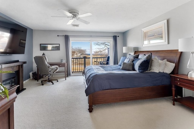 carpeted bedroom with access to outside and ceiling fan