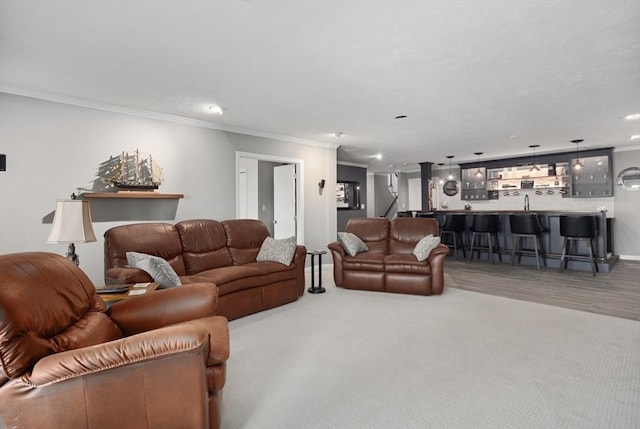 living room featuring crown molding, indoor bar, and carpet floors