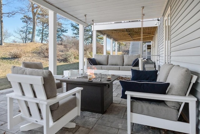 view of patio featuring an outdoor living space with a fire pit