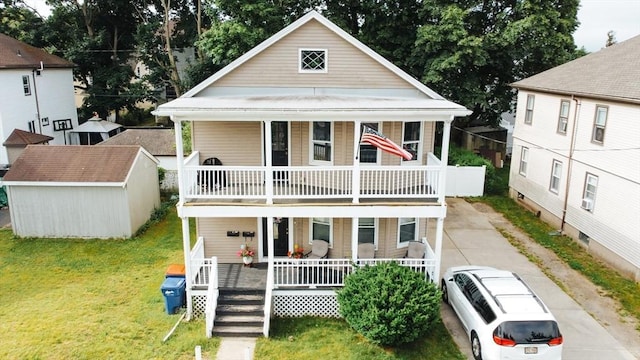 27 Morgan St, Fairhaven, MA 02719 - view of front of property with covered porch, a balcony, a front yard, and an outdoor structure
