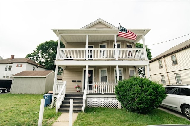 27 Morgan St, Fairhaven, MA 02719 - view of front facade with covered porch, a shed, a balcony, and a front yard