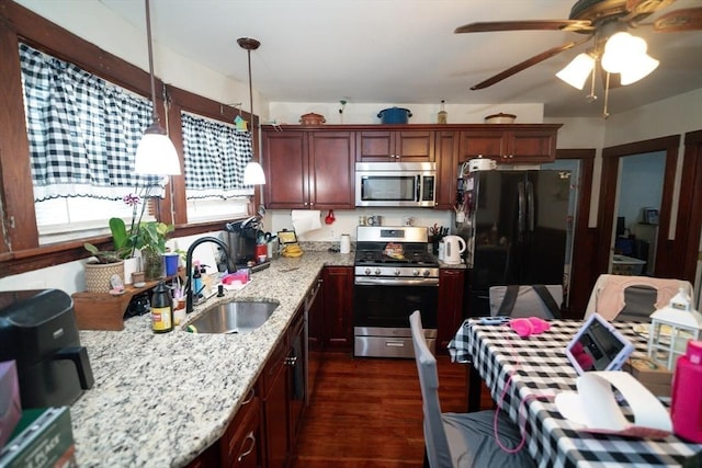 27 Morgan St, Fairhaven, MA 02719 - kitchen with stainless steel appliances, dark wood-style flooring, a ceiling fan, decorative light fixtures, and light stone counters