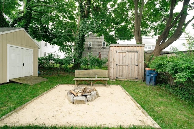 27 Morgan St, Fairhaven, MA 02719 - view of green lawn featuring a storage shed, an outdoor fire pit, and a patio area