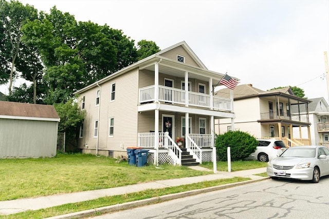 27 Morgan St, Fairhaven, MA 02719 - view of front of home with covered porch, a balcony, a front yard, and an outdoor structure