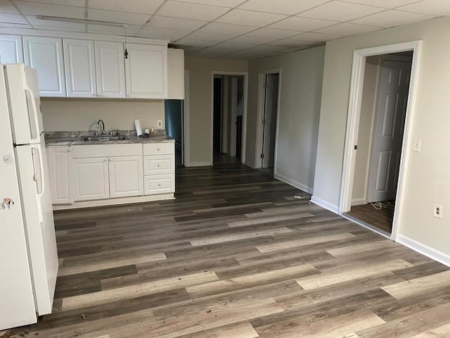 160 7th St, Leominster, MA 01453 - kitchen featuring freestanding refrigerator, white cabinets, dark wood-type flooring, and a paneled ceiling
