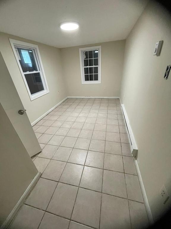 160 7th St, Leominster, MA 01453 - unfurnished room with light tile patterned floors and a baseboard radiator