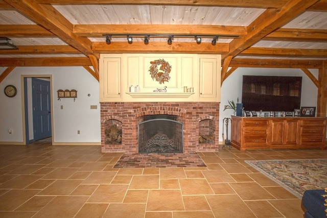 unfurnished living room featuring beamed ceiling, tile patterned flooring, and rail lighting