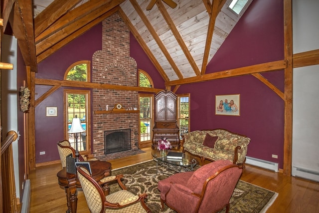 living room featuring a brick fireplace, high vaulted ceiling, beamed ceiling, a baseboard radiator, and hardwood / wood-style flooring