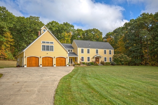 view of front of home with a garage and a front lawn