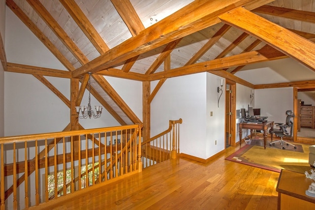 interior space featuring vaulted ceiling with beams, an inviting chandelier, wood ceiling, and hardwood / wood-style flooring