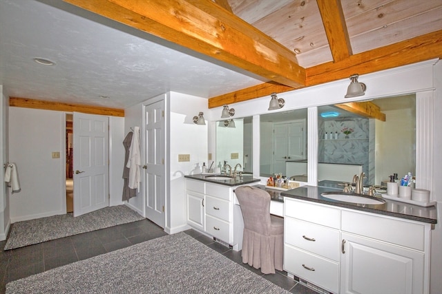 bathroom featuring vanity, beamed ceiling, and tile patterned floors